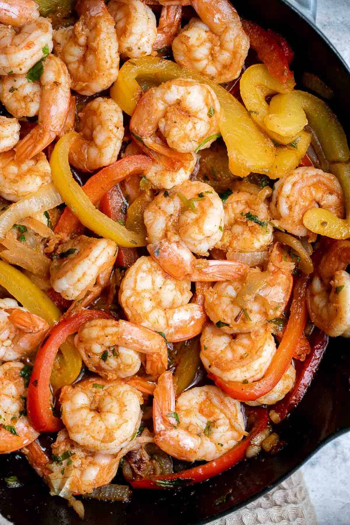 Shrimp fajitas are healthy, flavorful, and delicious. This one skillet recipe is loaded with shrimp and vegetables and is ready in just 20 minutes. | aheadofthyme.com