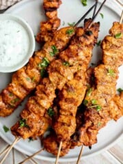 Grilled Tandoori Chicken Skewers served with creamy yogurt dipping sauce.