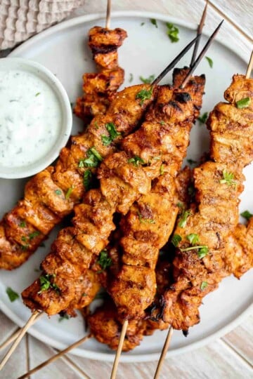Grilled Tandoori Chicken Skewers served with creamy yogurt dipping sauce.