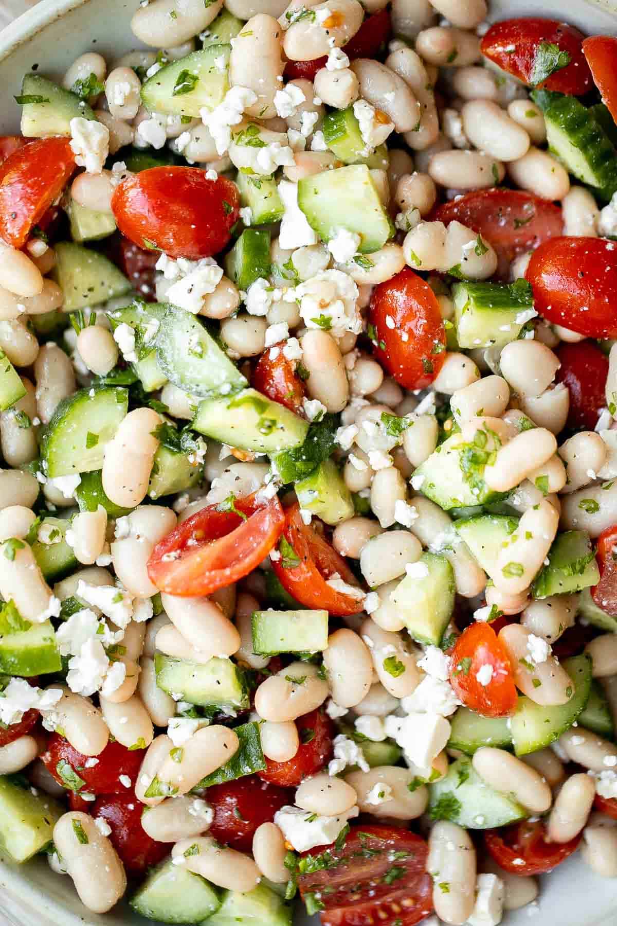 Mediterranean White Bean Salad is loaded with cannellini beans, veggies, feta, and fresh herbs, tossed in a homemade Greek dressing. Perfect for meal prep! | aheadofthyme.com