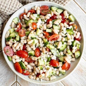 Mediterranean White Bean Salad is loaded with cannellini beans, veggies, feta, and fresh herbs, tossed in a homemade Greek dressing. Perfect for meal prep! | aheadofthyme.com