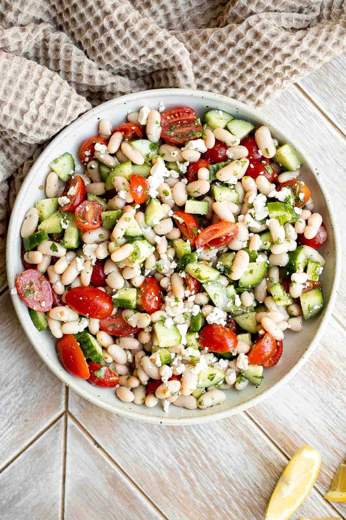 Mediterranean White Bean Salad is loaded with cannellini beans, veggies, feta, and fresh herbs, tossed in a homemade Greek dressing. Perfect for meal prep! | aheadofthyme.com