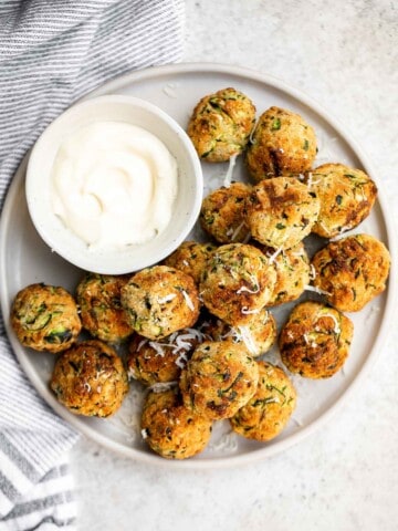 Zucchini Bites are savory balls that are loaded with fresh zucchini. They're quick and easy to make in under 30 minutes in the air fryer or oven. | aheadofthyme.com