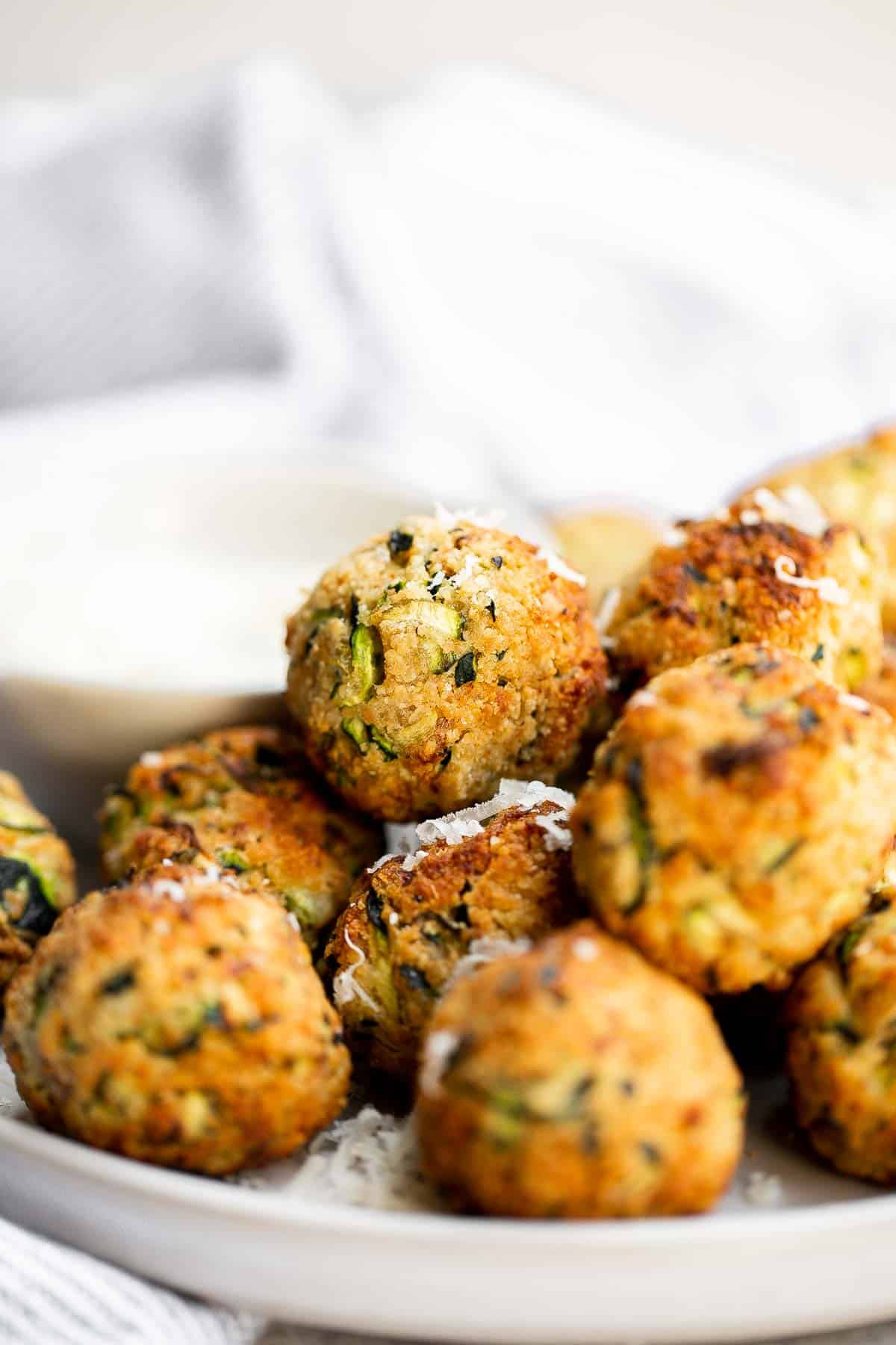 Zucchini Bites are savory balls that are loaded with fresh zucchini. They're quick and easy to make in under 30 minutes in the air fryer or oven. | aheadofthyme.com