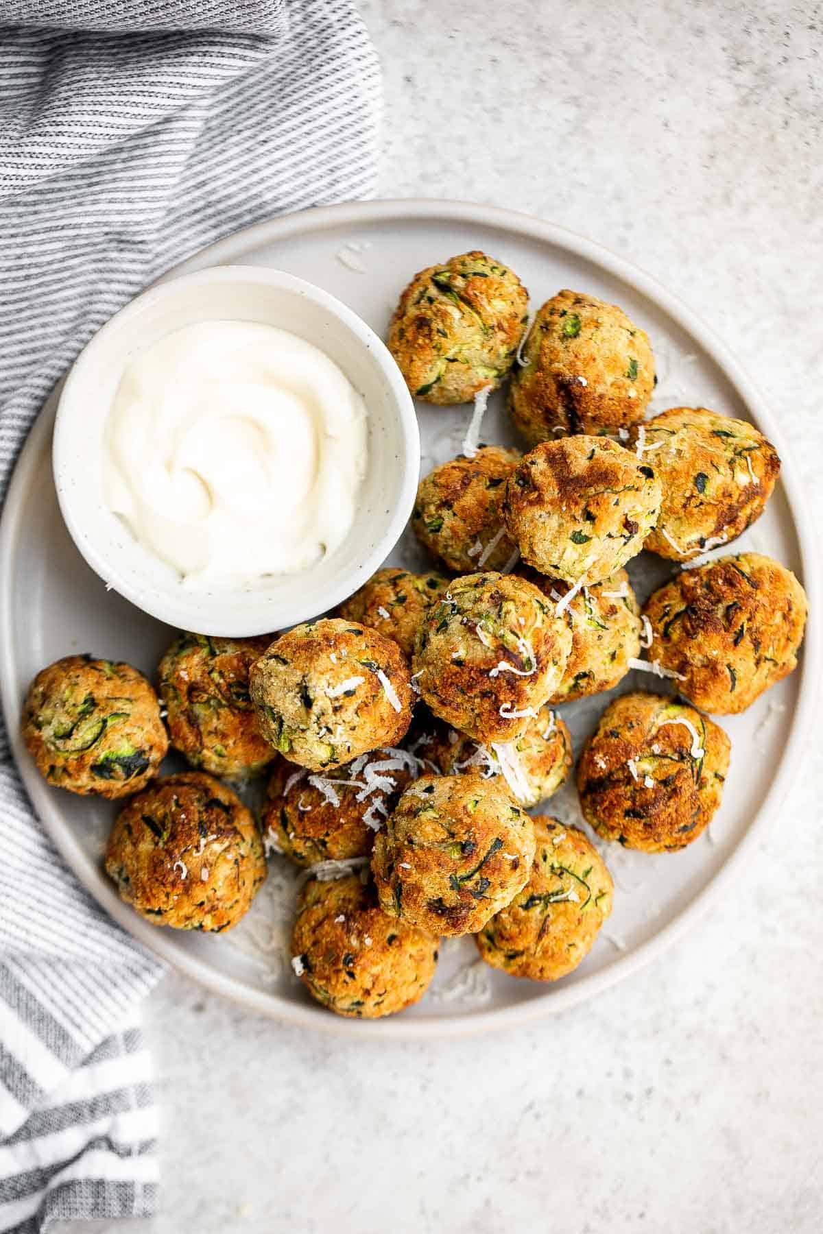 Zucchini Bites are savory balls that are loaded with fresh zucchini. They're quick and easy to make in under 30 minutes in the air fryer or oven. | aheadofthyme.com