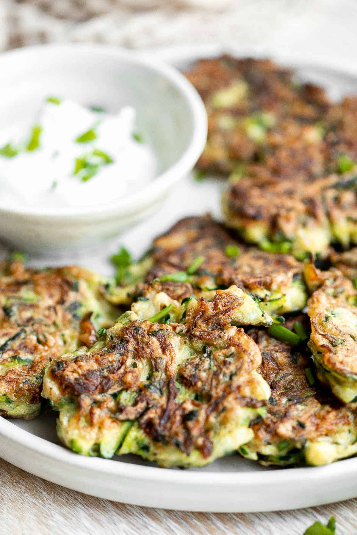Zucchini fritters are crispy outside, tender inside, and loaded with zucchini. These healthy bites are one of my favorite ways to use up summer zucchini. | aheadofthyme.com