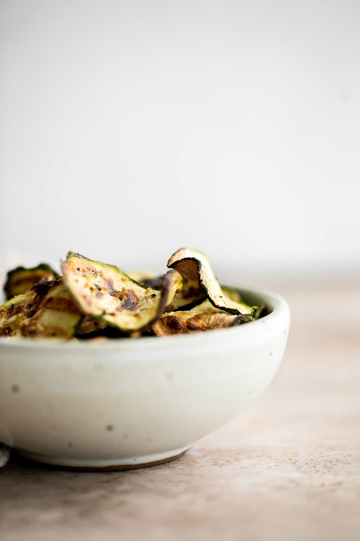 Air fryer zucchini chips make an excellent snack or side dish — they are savory, salty, and flavorful! A quick and easy recipe made with 5 ingredients. | aheadofthyme.com