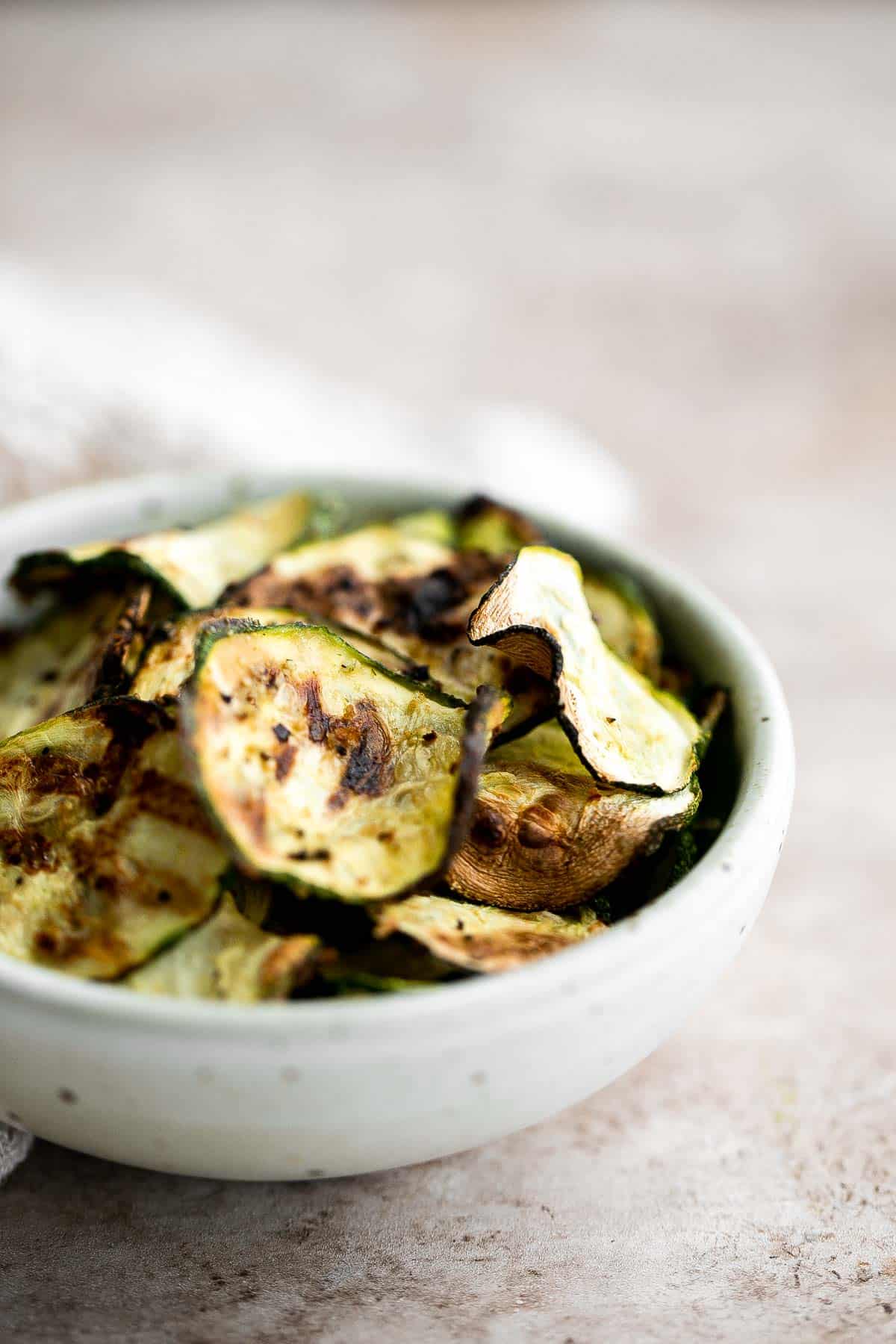 Air fryer zucchini chips make an excellent snack or side dish — they are savory, salty, and flavorful! A quick and easy recipe made with 5 ingredients. | aheadofthyme.com