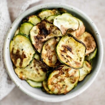 Air fryer zucchini chips make an excellent snack or side dish — they are savory, salty, and flavorful! A quick and easy recipe made with 5 ingredients. | aheadofthyme.com