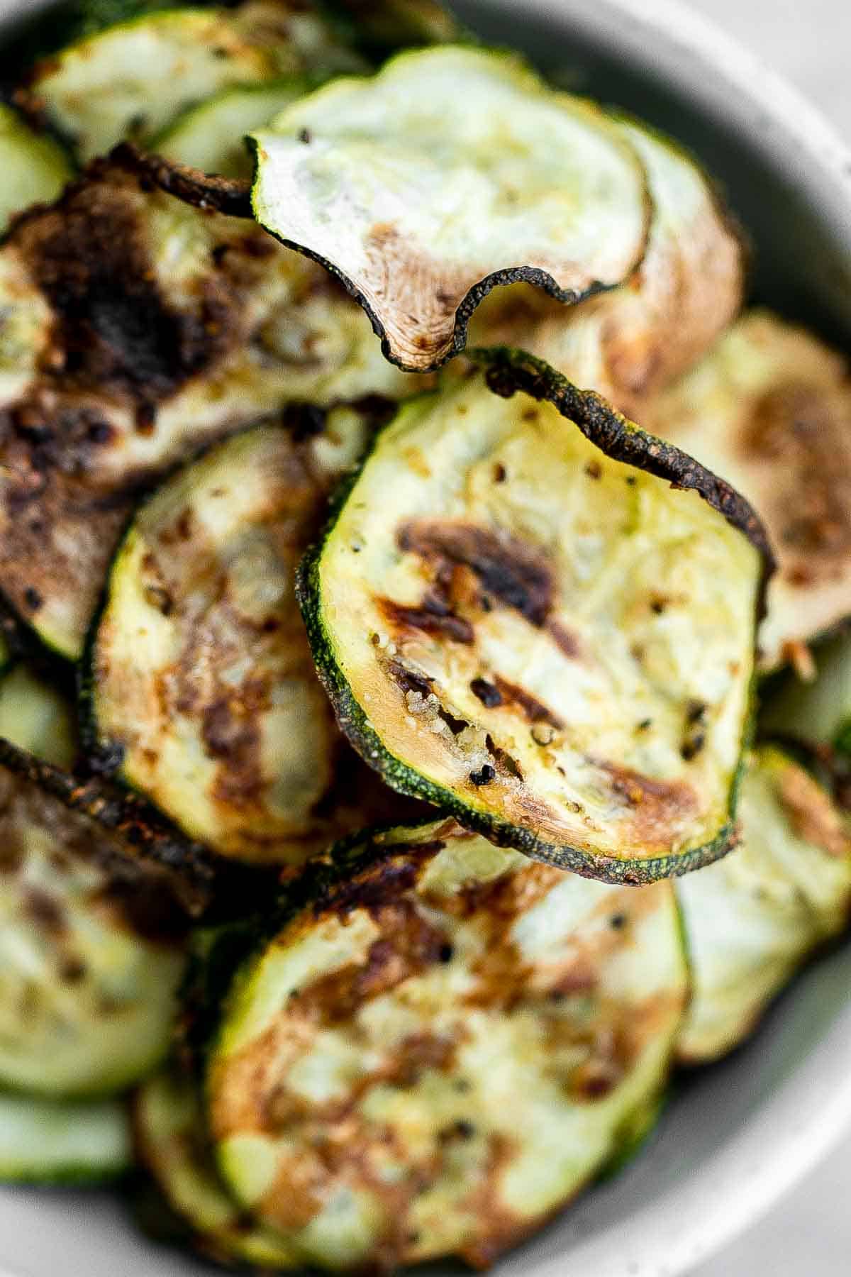 Air fryer zucchini chips make an excellent snack or side dish — they are savory, salty, and flavorful! A quick and easy recipe made with 5 ingredients. | aheadofthyme.com