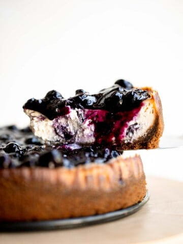 This Blueberry Cheesecake is rich, sweet, and smooth with a creamy cheesecake layer packed with blueberries and topped with sweet blueberry sauce. | aheadofthyme.com