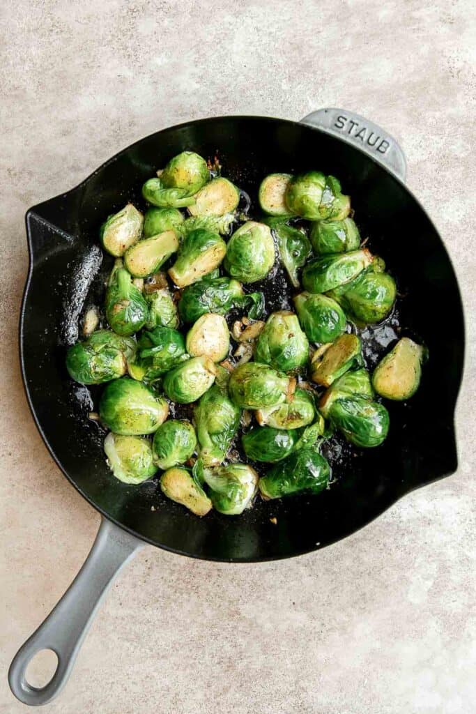 Brussels Sprouts with Bacon is a quick and easy side dish with the best flavor and texture. The best part? This holiday side is ready in under 15 minutes. | aheadofthyme.com