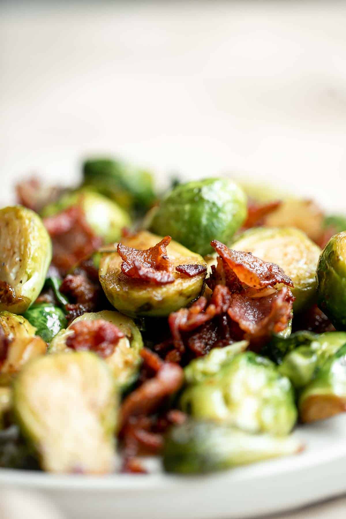 Brussels Sprouts with Bacon is a quick and easy side dish with the best flavor and texture. The best part? This holiday side is ready in under 15 minutes. | aheadofthyme.com