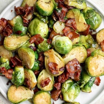 Brussels Sprouts with Bacon is a quick and easy side dish with the best flavor and texture. The best part? This holiday side is ready in under 15 minutes. | aheadofthyme.com