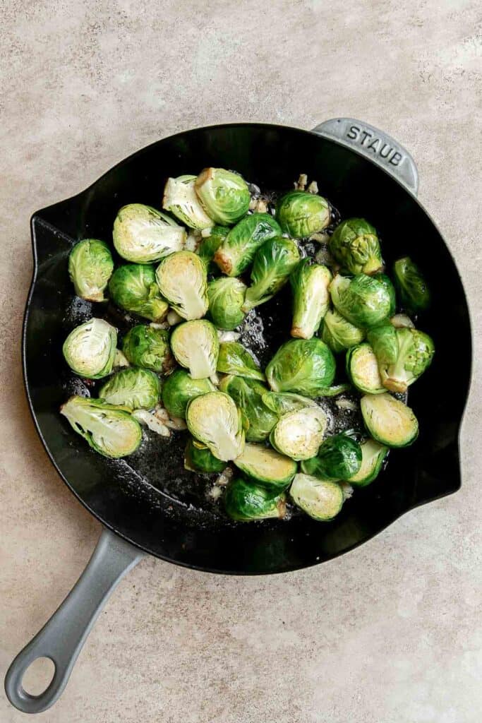 Brussels Sprouts with Bacon is a quick and easy side dish with the best flavor and texture. The best part? This holiday side is ready in under 15 minutes. | aheadofthyme.com