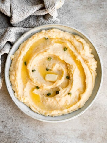 Cheddar Mashed Potatoes are fluffy, creamy, and buttery. Loaded with cheese and hints of garlic, every bite of this classic side dish is flavorful. | aheadofthyme.com