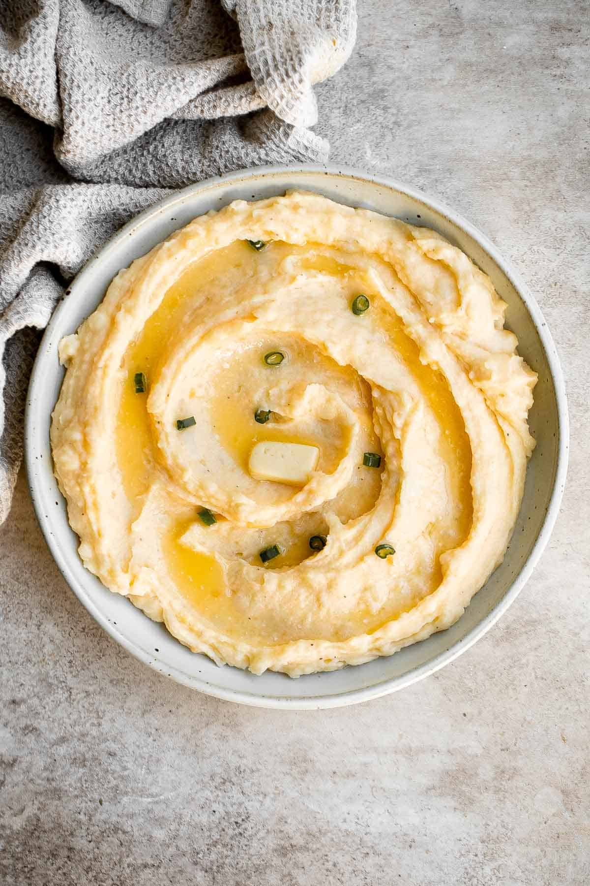 Cheddar Mashed Potatoes are fluffy, creamy, and buttery. Loaded with cheese and hints of garlic, every bite of this classic side dish is flavorful. | aheadofthyme.com