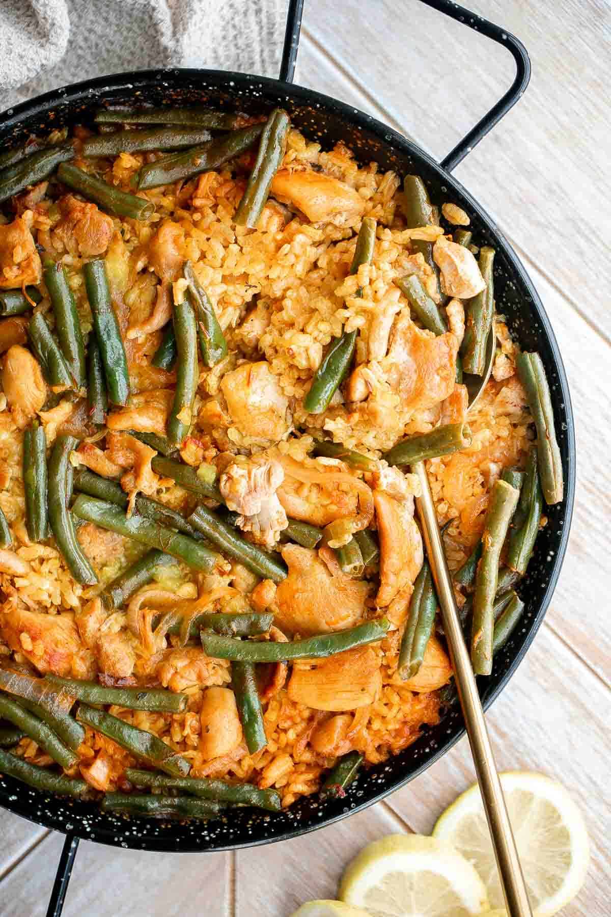 Authentic Chicken Paella (Paella Valenciana) is delicious and filling. It’s loaded with protein, veggies, and rice, cooked in a flavorful saffron broth. | aheadofthyme.com