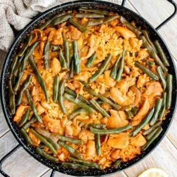 Authentic Chicken Paella (Paella Valenciana) is delicious and filling. It’s loaded with protein, veggies, and rice, cooked in a flavorful saffron broth. | aheadofthyme.com