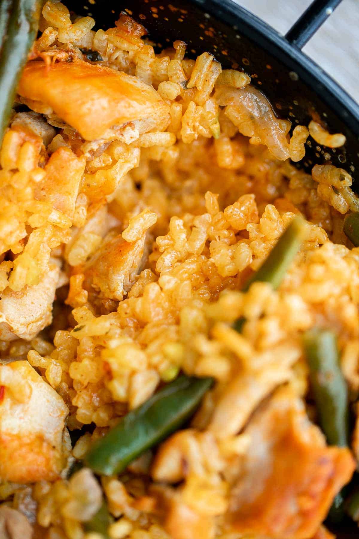 Authentic Chicken Paella (Paella Valenciana) is delicious and filling. It’s loaded with protein, veggies, and rice, cooked in a flavorful saffron broth. | aheadofthyme.com