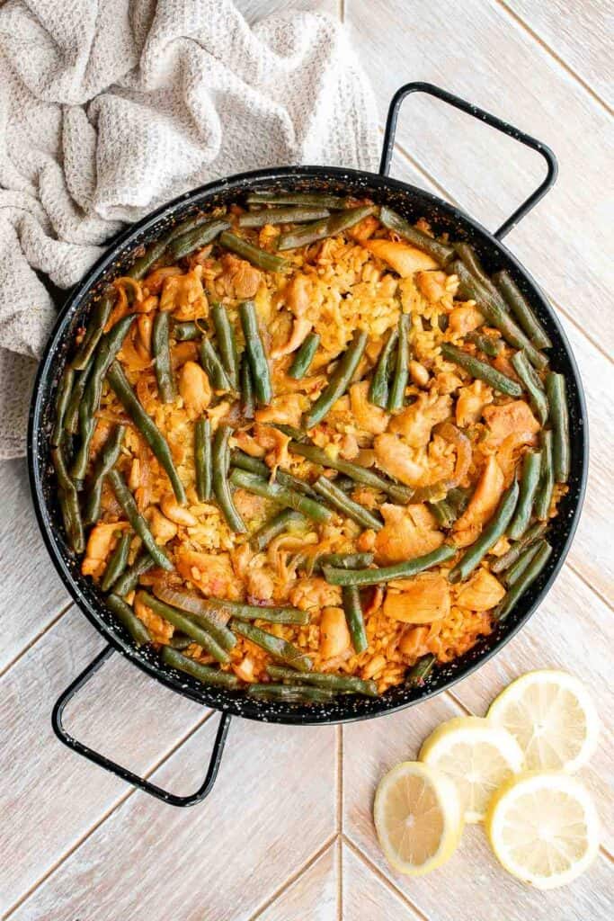 Authentic Chicken Paella (Paella Valenciana) is delicious and filling. It’s loaded with protein, veggies, and rice, cooked in a flavorful saffron broth. | aheadofthyme.com