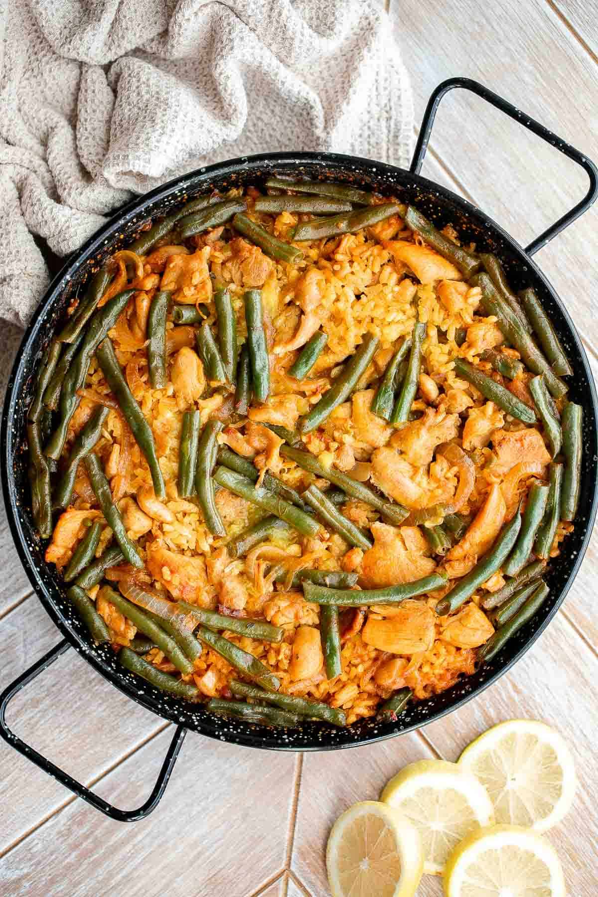 Authentic Chicken Paella (Paella Valenciana) is delicious and filling. It’s loaded with protein, veggies, and rice, cooked in a flavorful saffron broth. | aheadofthyme.com
