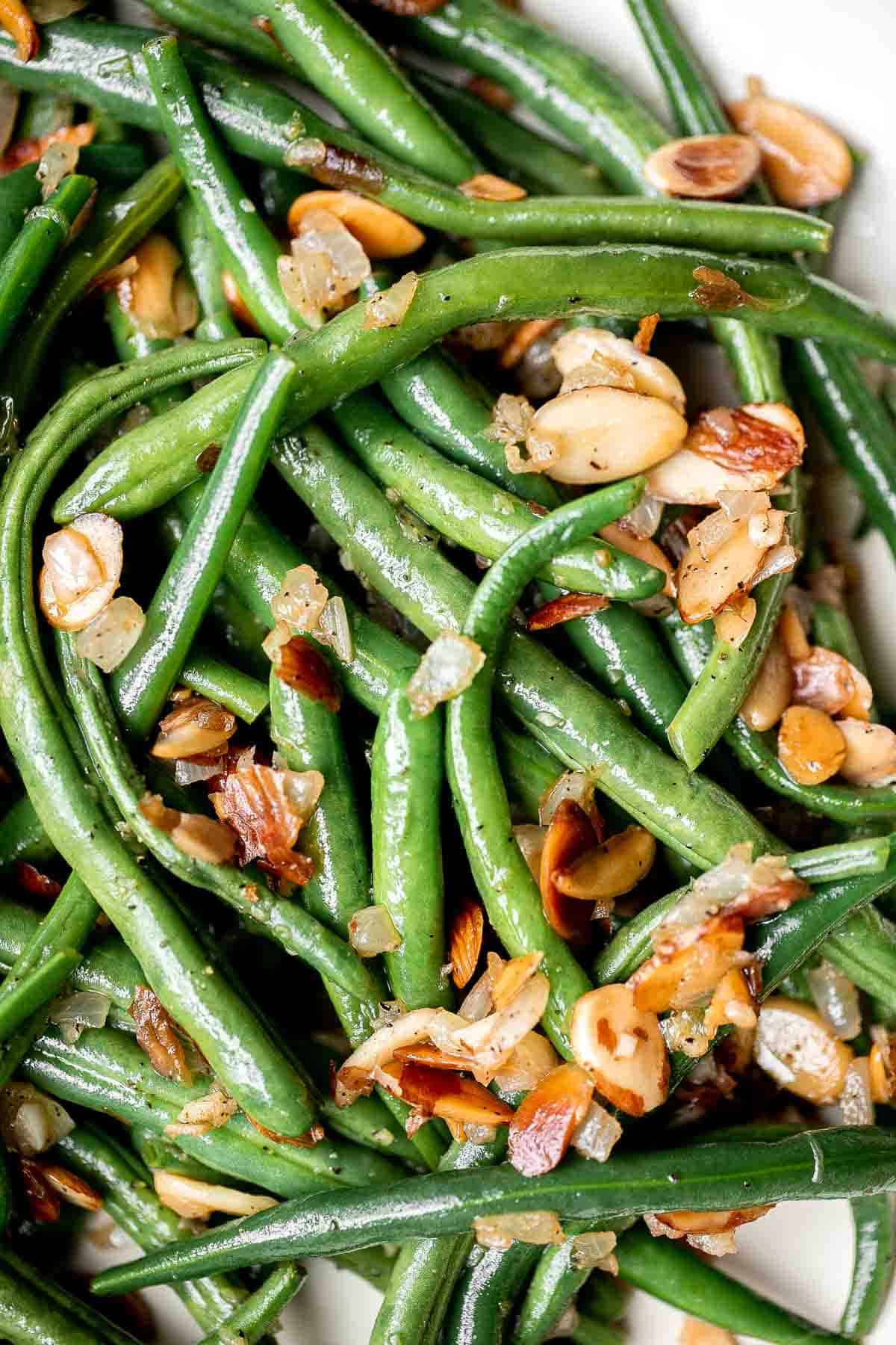 Green Beans Almondine is buttery, garlicky, and nutty. This classic French side dish is quick and easy to make, and loaded with flavor and texture. | aheadofthyme.com