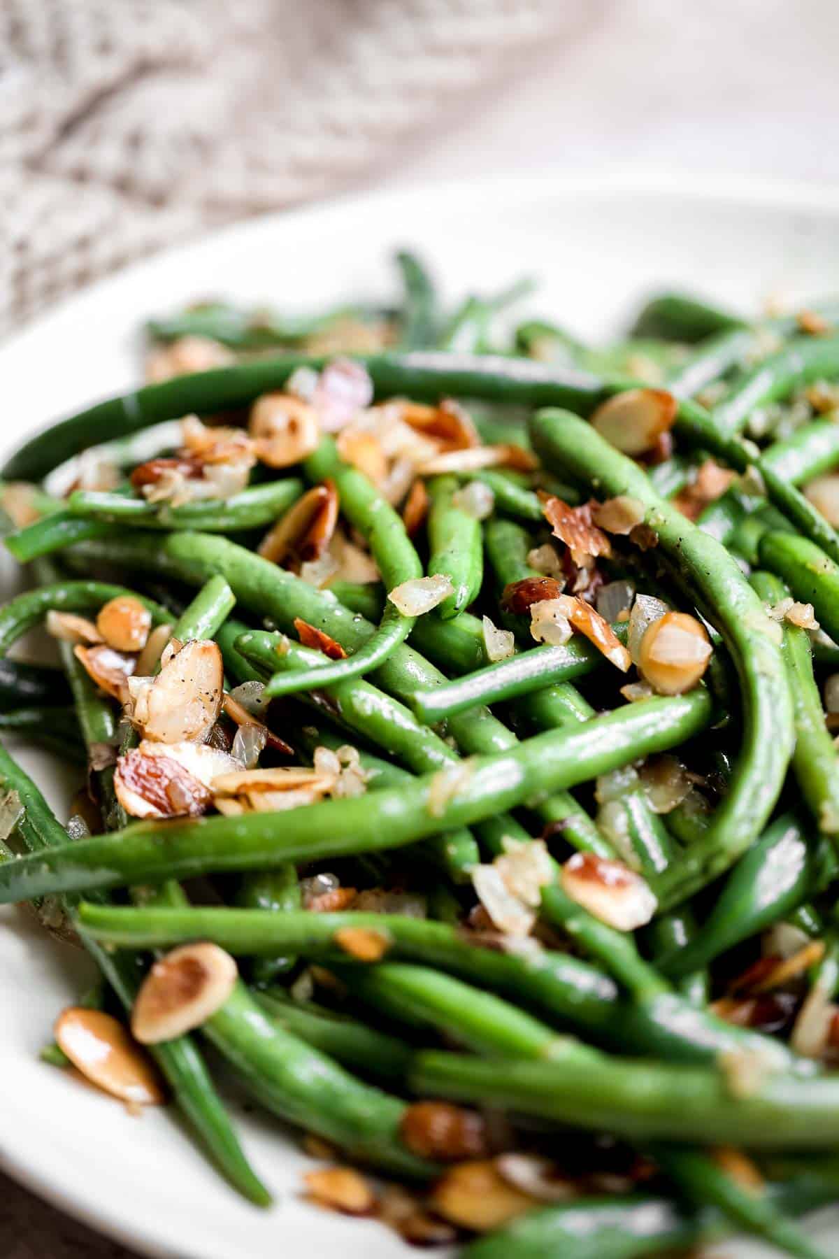 Green Beans Almondine is buttery, garlicky, and nutty. This classic French side dish is quick and easy to make, and loaded with flavor and texture. | aheadofthyme.com