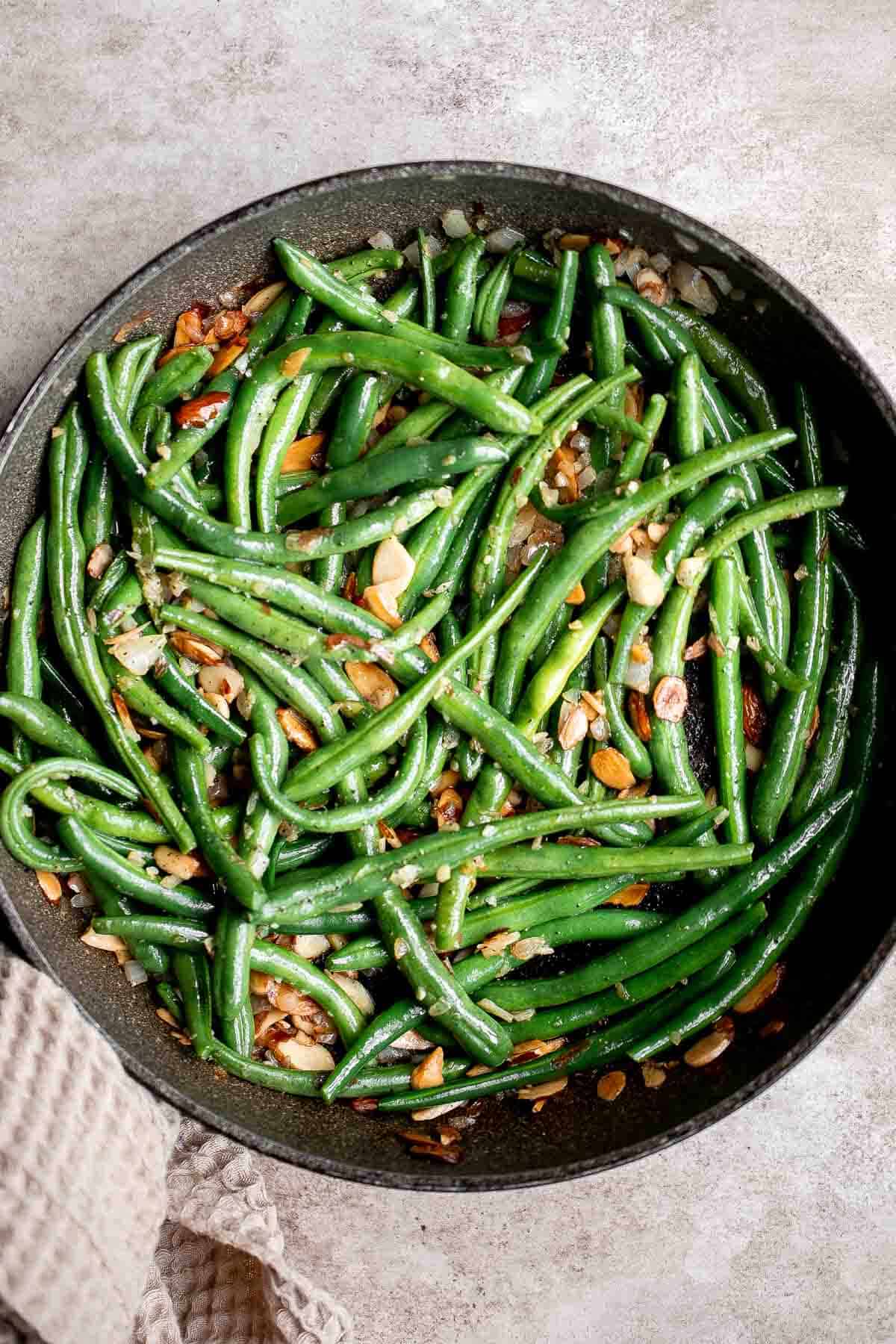 Green Beans Almondine is buttery, garlicky, and nutty. This classic French side dish is quick and easy to make, and loaded with flavor and texture. | aheadofthyme.com