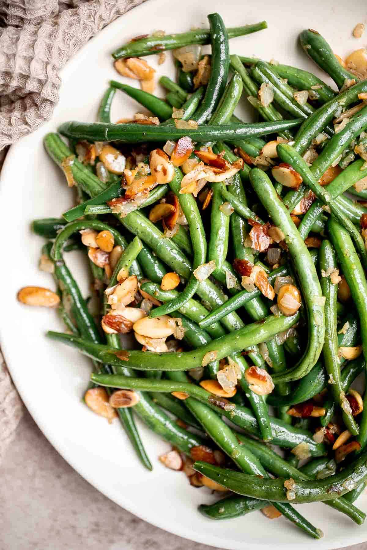 Green Beans Almondine is buttery, garlicky, and nutty. This classic French side dish is quick and easy to make, and loaded with flavor and texture. | aheadofthyme.com