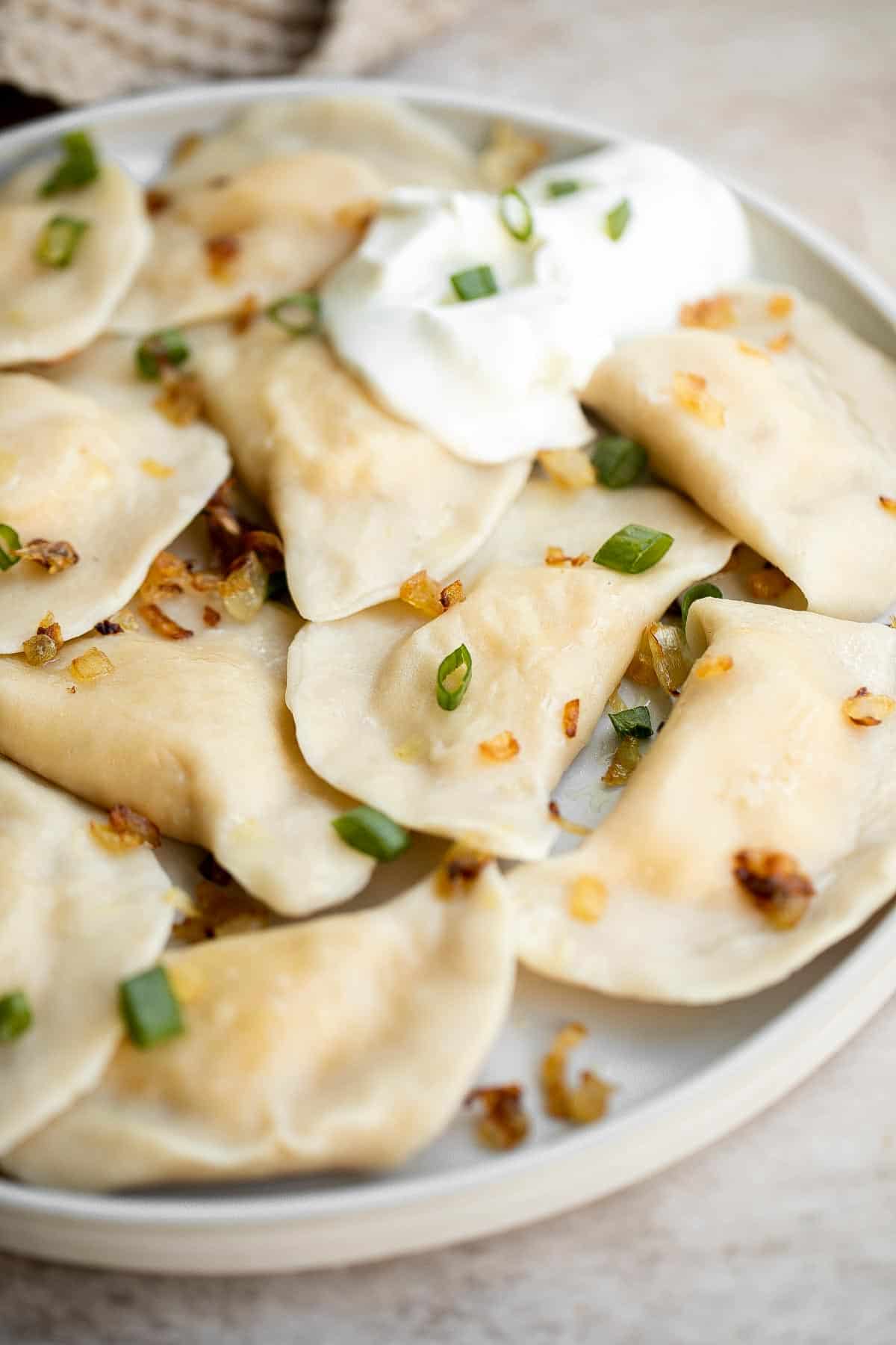 Homemade Potato and Cheese Perogies are comforting, delicious, and satisfying. These cheddar pierogi from scratch as easier to make than you think! | aheadofthyme.com