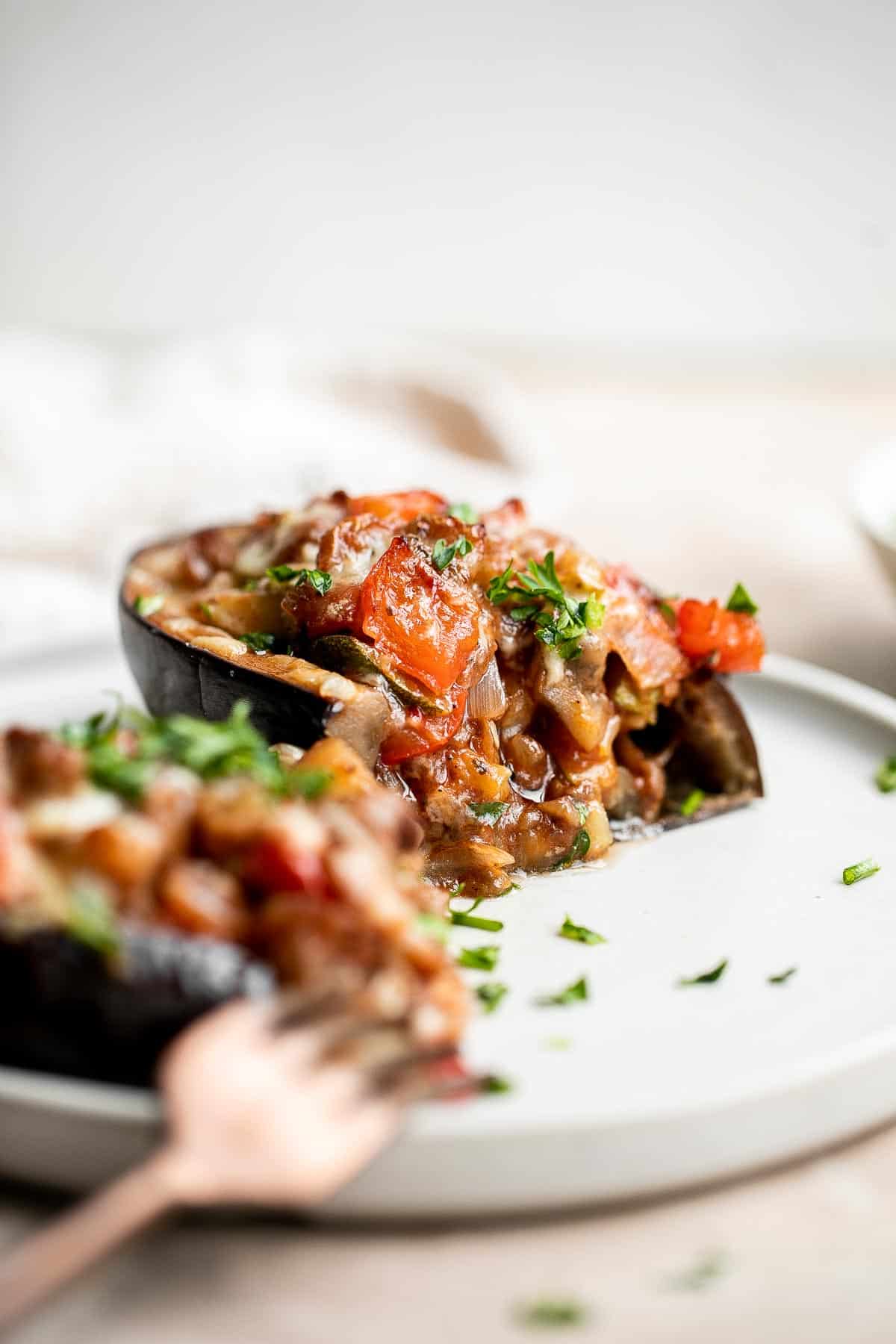 This Mediterranean Stuffed Eggplant is delicious, filling, and healthy. This vegetarian dinner is loaded with veggies and topped with bubbly cheese. | aheadofthyme.com