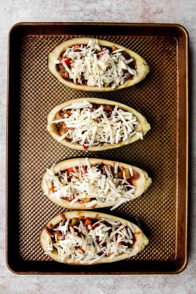 This Mediterranean Stuffed Eggplant is delicious, filling, and healthy. This vegetarian dinner is loaded with veggies and topped with bubbly cheese. | aheadofthyme.com