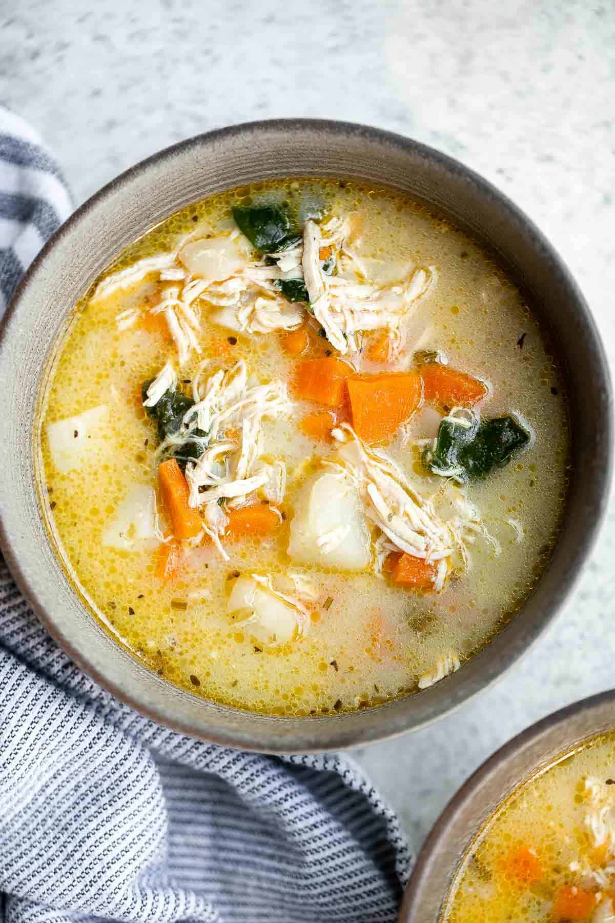 Chicken Potato Soup is cozy, hearty, and delicious — loaded with chicken, potatoes, veggies, and greens simmered in a creamy broth. Ready in 40 minutes. | aheadofthyme.com