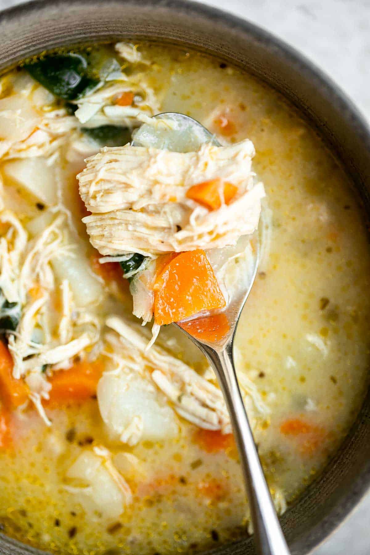 Chicken Potato Soup is cozy, hearty, and delicious — loaded with chicken, potatoes, veggies, and greens simmered in a creamy broth. Ready in 40 minutes. | aheadofthyme.com