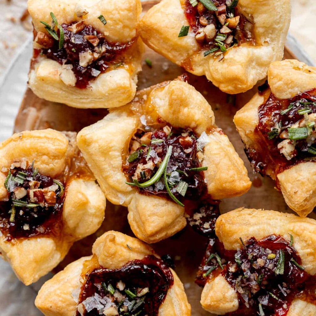 Cranberry Brie Bites are quick and easy to make with flaky puff pastry, gooey melty brie, and sweet cranberry sauce. The perfect holiday appetizer. | aheadofthyme.com