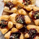 Cranberry Brie Bites are quick and easy to make with flaky puff pastry, gooey melty brie, and sweet cranberry sauce. The perfect holiday appetizer. | aheadofthyme.com