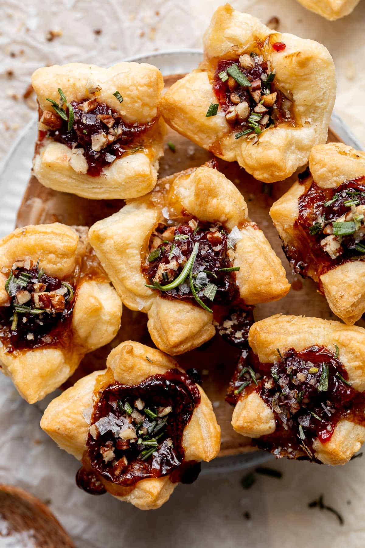 Cranberry Brie Bites are quick and easy to make with flaky puff pastry, gooey melty brie, and sweet cranberry sauce. The perfect holiday appetizer. | aheadofthyme.com