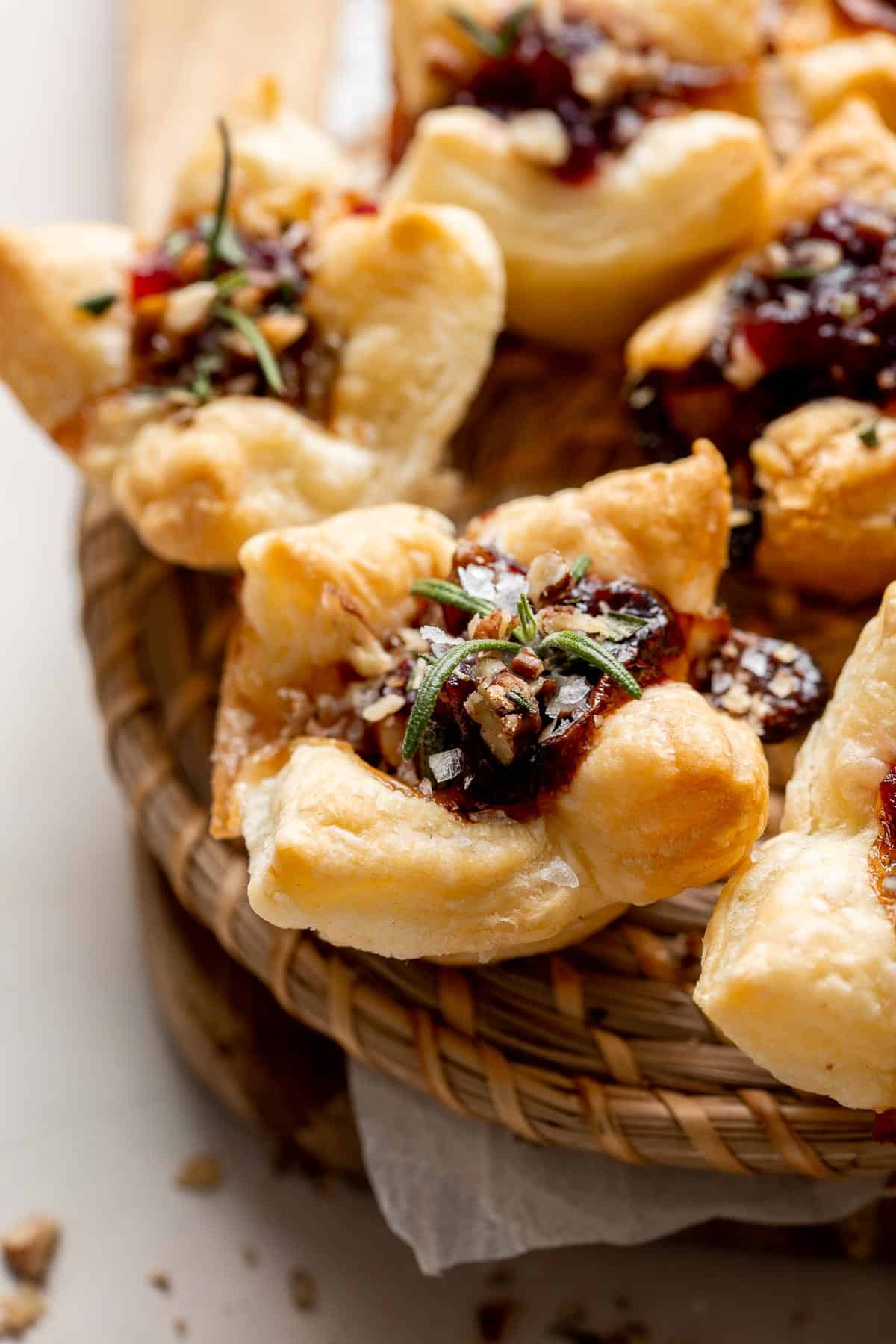 Cranberry Brie Bites are quick and easy to make with flaky puff pastry, gooey melty brie, and sweet cranberry sauce. The perfect holiday appetizer. | aheadofthyme.com