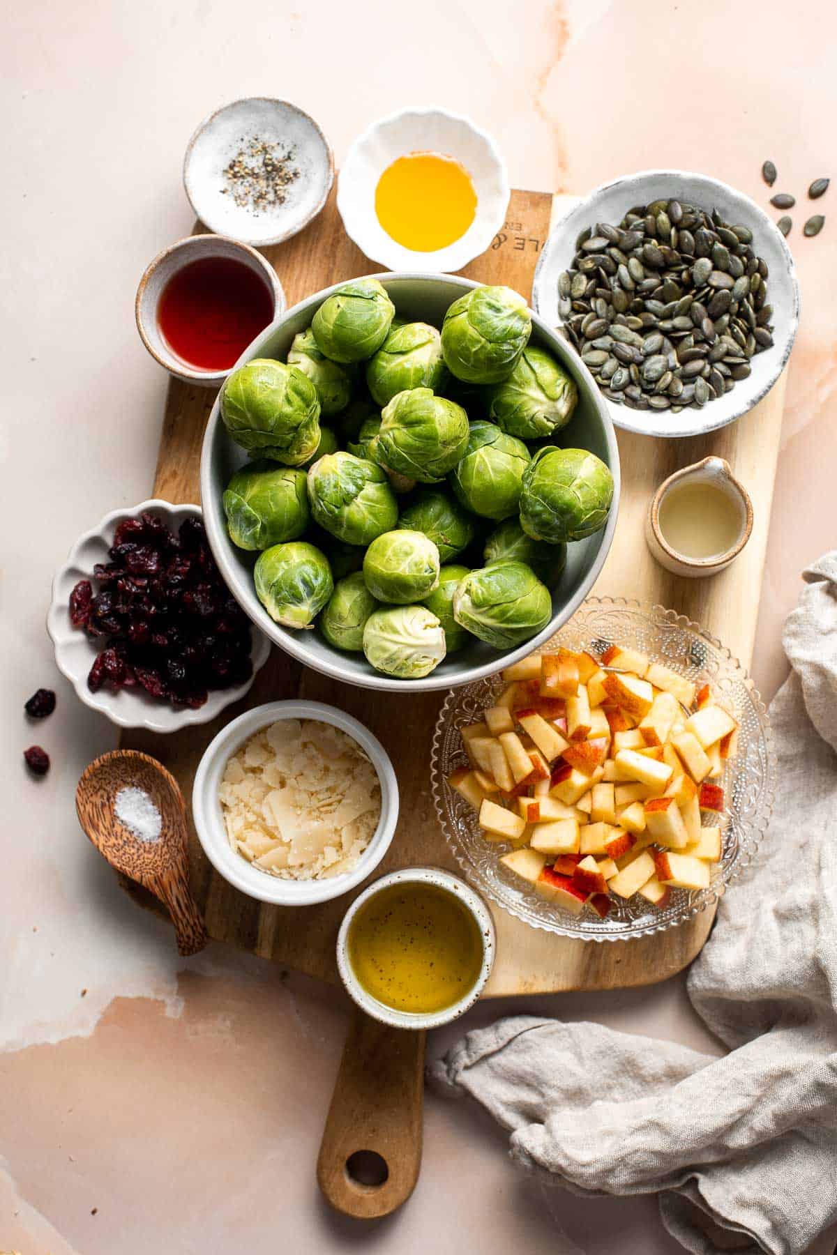 Shaved Brussels Sprout Salad is a delicious fall salad packed with fresh sprouts, apples, cranberries, and crunchy seeds, tossed in a homemade vinaigrette. | aheadofthyme.com