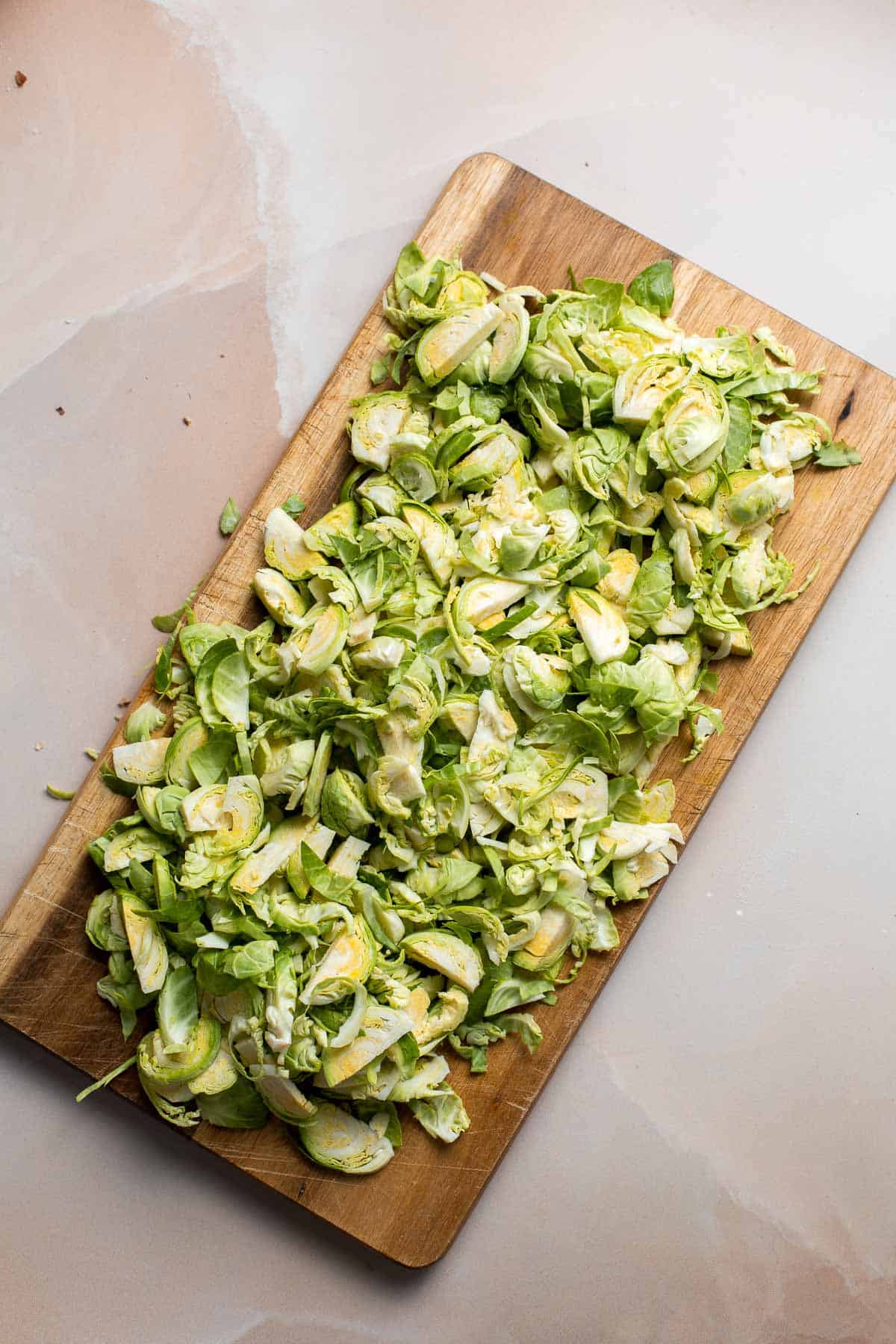 Shaved Brussels Sprout Salad is a delicious fall salad packed with fresh sprouts, apples, cranberries, and crunchy seeds, tossed in a homemade vinaigrette. | aheadofthyme.com