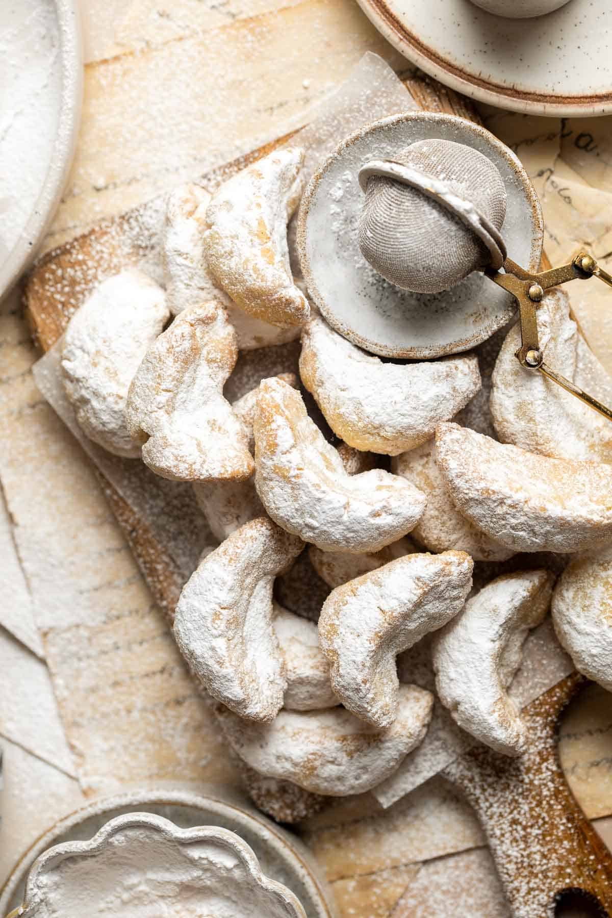 Almond Crescent Cookies are delicious and crumbly half-moon shaped cookies with a fragrant, sweet almond flavor and a delicate dusting of powdered sugar. | aheadofthyme.com