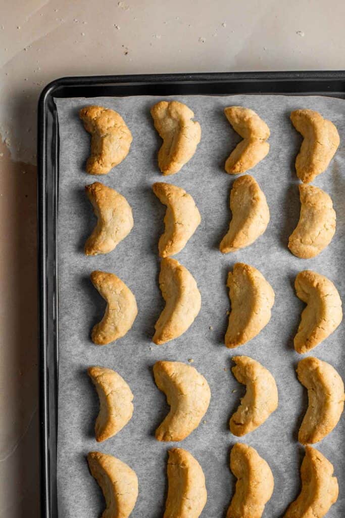 Almond Crescent Cookies are delicious and crumbly half-moon shaped cookies with a fragrant, sweet almond flavor and a delicate dusting of powdered sugar. | aheadofthyme.com