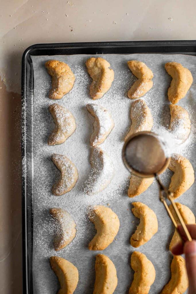 Almond Crescent Cookies are delicious and crumbly half-moon shaped cookies with a fragrant, sweet almond flavor and a delicate dusting of powdered sugar. | aheadofthyme.com