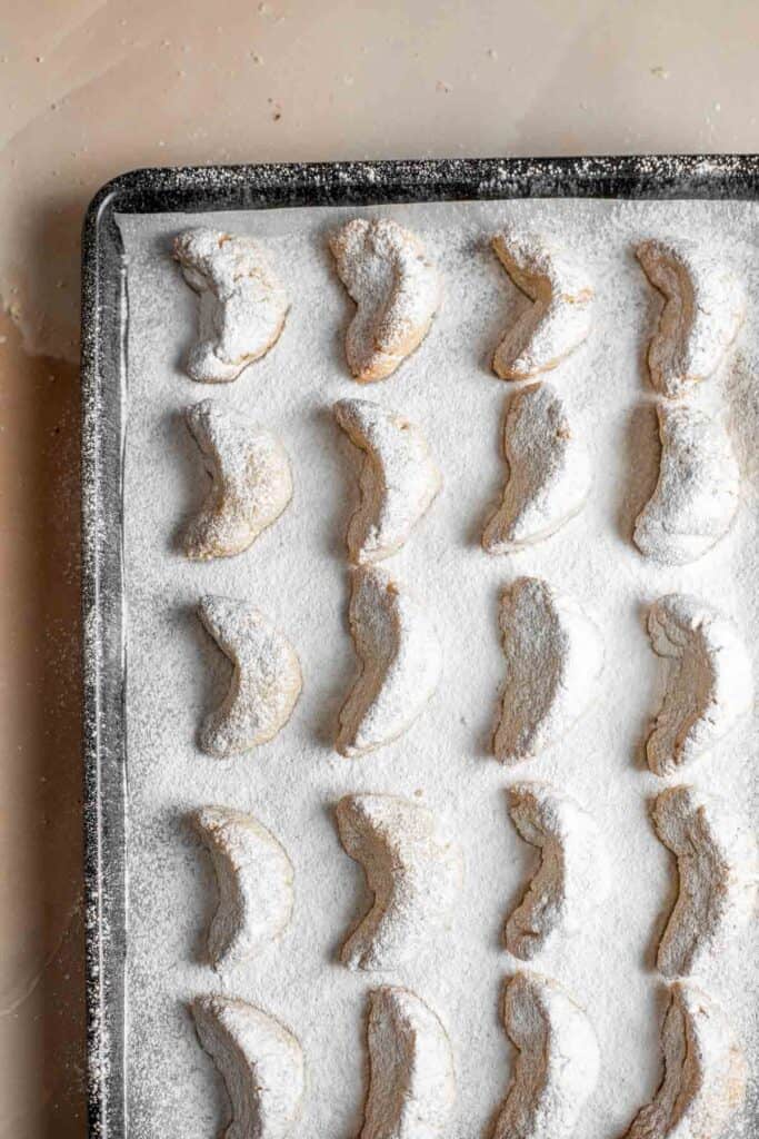 Almond Crescent Cookies are delicious and crumbly half-moon shaped cookies with a fragrant, sweet almond flavor and a delicate dusting of powdered sugar. | aheadofthyme.com
