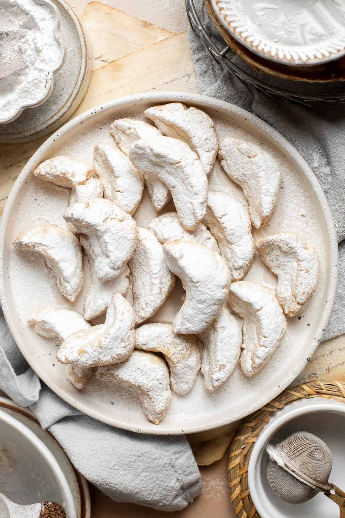 Almond Crescent Cookies are delicious and crumbly half-moon shaped cookies with a fragrant, sweet almond flavor and a delicate dusting of powdered sugar. | aheadofthyme.com