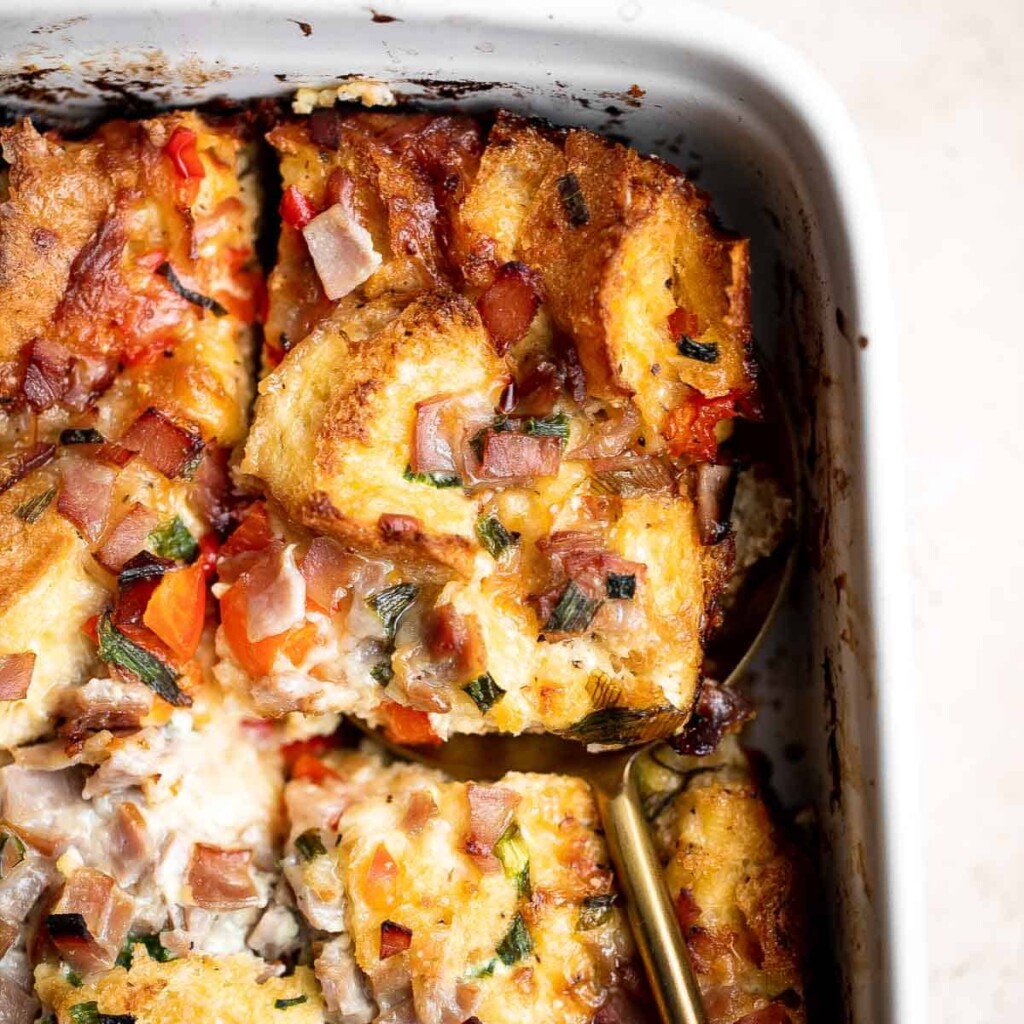 Breakfast Strata is a hearty baked casserole dish loaded with bread, eggs, ham, cheese, and veggies that will keep you full until lunchtime. | aheadofthyme.com