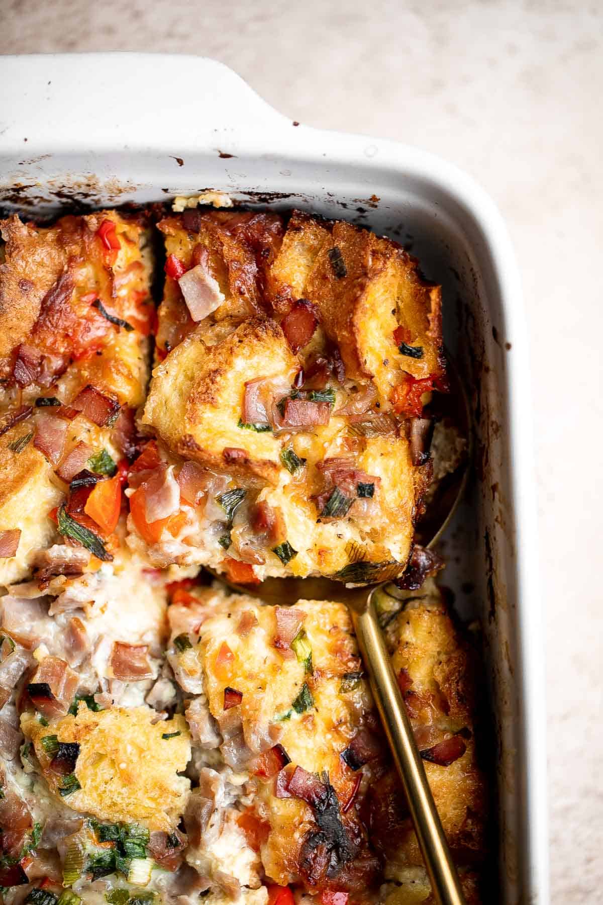 Breakfast Strata is a hearty baked casserole dish loaded with bread, eggs, ham, cheese, and veggies that will keep you full until lunchtime. | aheadofthyme.com