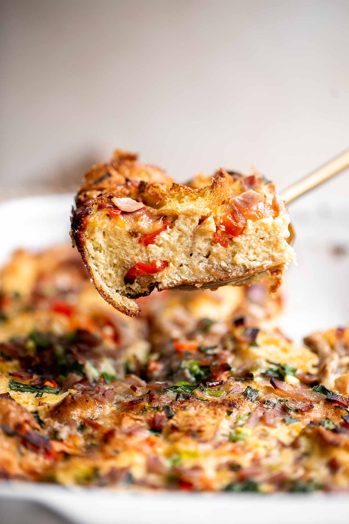 Breakfast Strata is a hearty baked casserole dish loaded with bread, eggs, ham, cheese, and veggies that will keep you full until lunchtime. | aheadofthyme.com