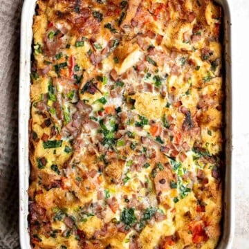 Breakfast Strata is a hearty baked casserole dish loaded with bread, eggs, ham, cheese, and veggies that will keep you full until lunchtime. | aheadofthyme.com